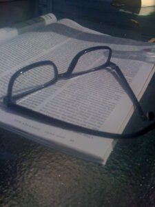 Reading glasses on top of an open book