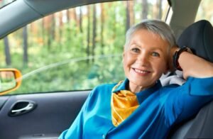 Older women sitting in a self driving car smiling
